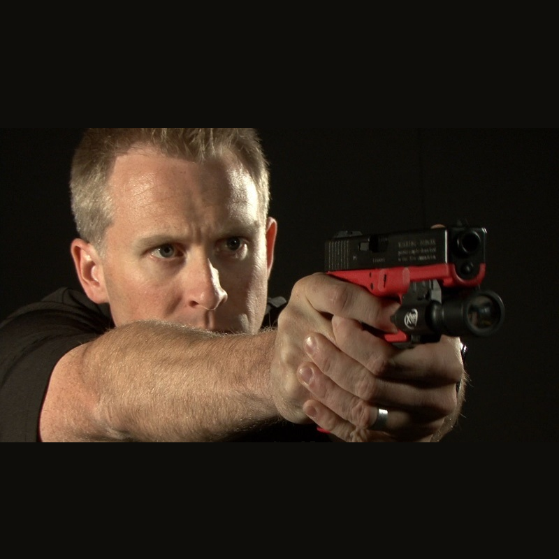 Instructor demonstrating firearm grip and sight alignment during confidence builder session